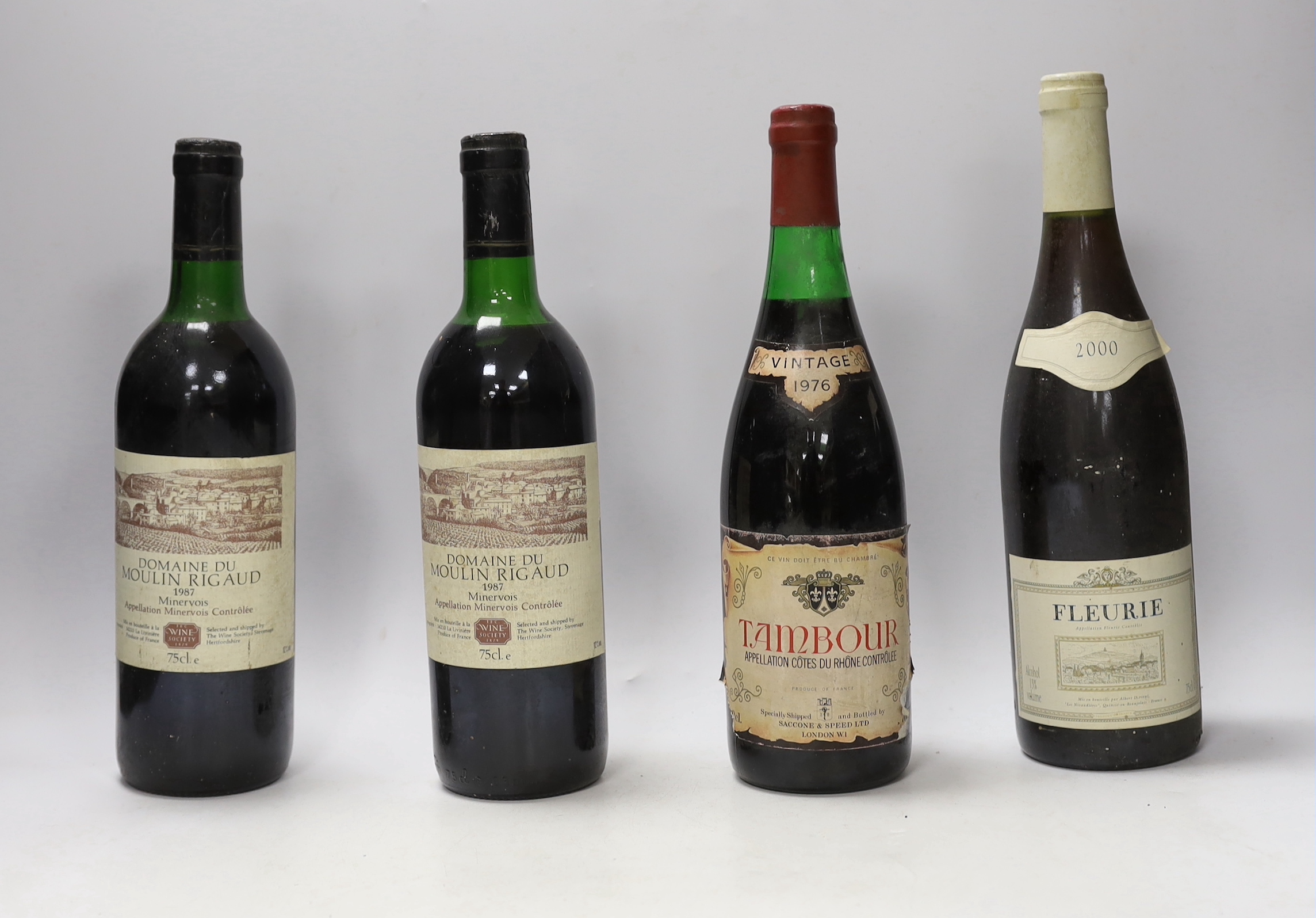Nine bottles of red wines: a bottle of Tambour Vintage Cote du Rhône 1976, two bottles of 1987 Domaine Du Moulin Riguad, a bottle of Chateau Recougne Bordeaux Superieur 2000, a bottle Fleurie 2000 and four other red wine